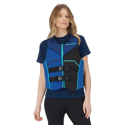 Woman wearing a blue and black life vest on a white background