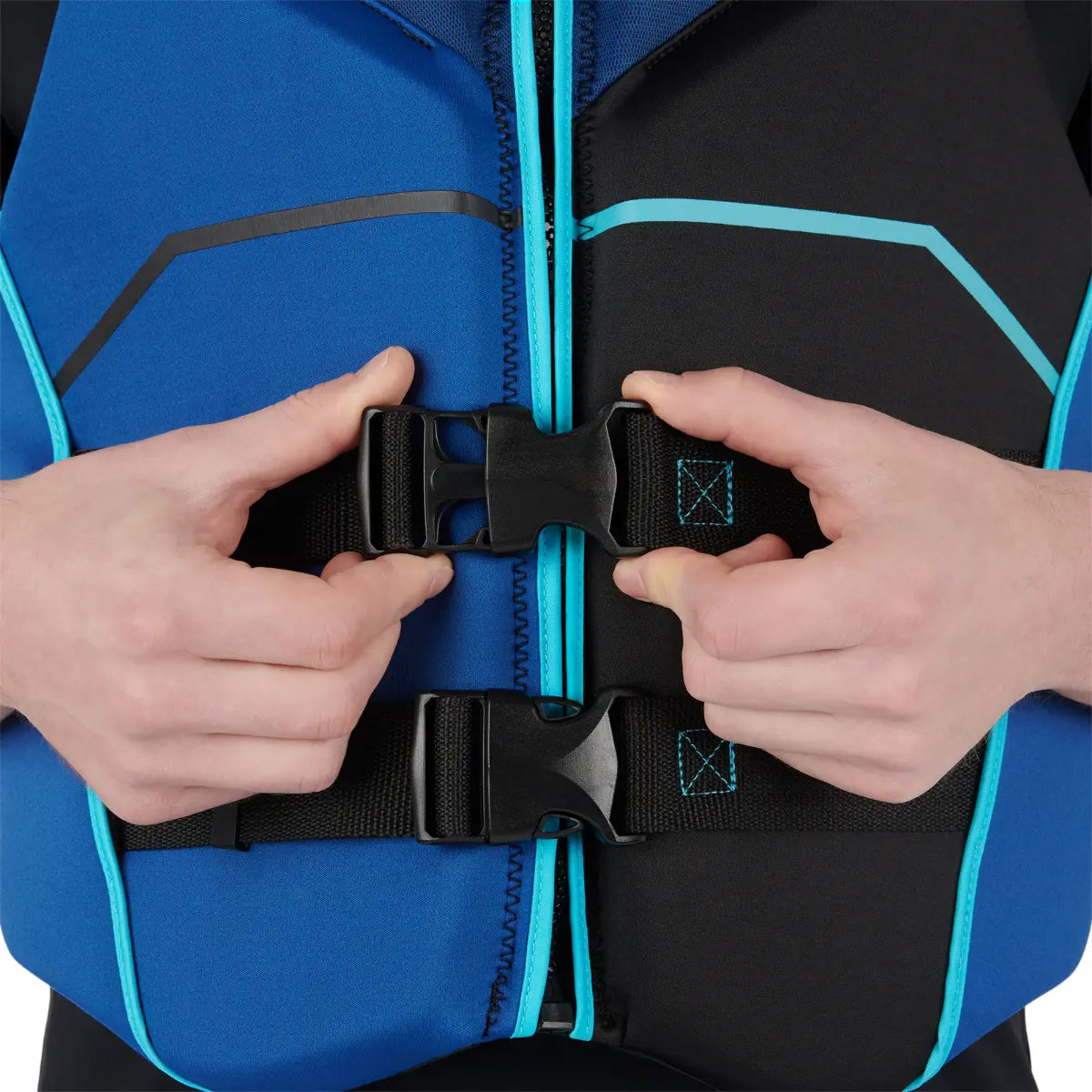 Close-up of hands adjusting a black strap on a blue and black jacket.